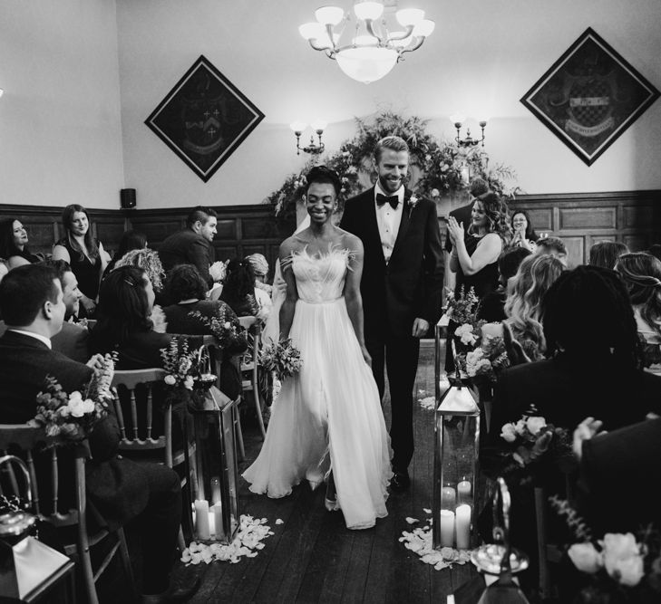 Bride and groom walking up the aisle as husband and wife