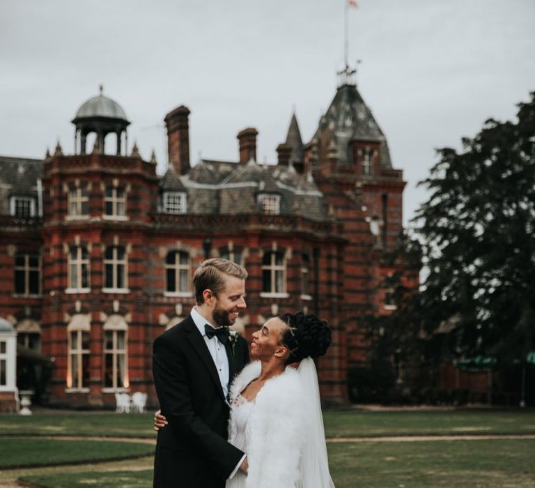 Wedding portrait by Natalie J Weddings of bride and groom outside  The Elvetham wedding venue in Hampshire