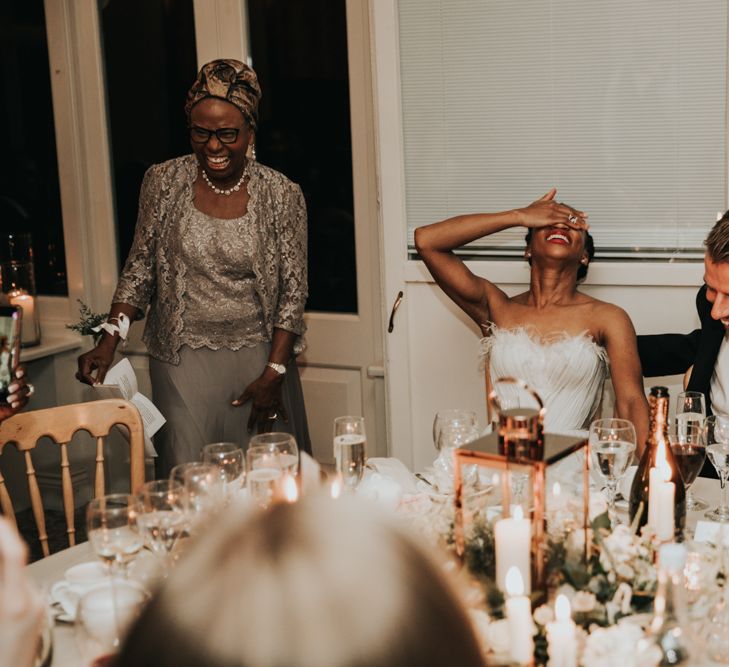 Bride and groom laughing during wedding speeches