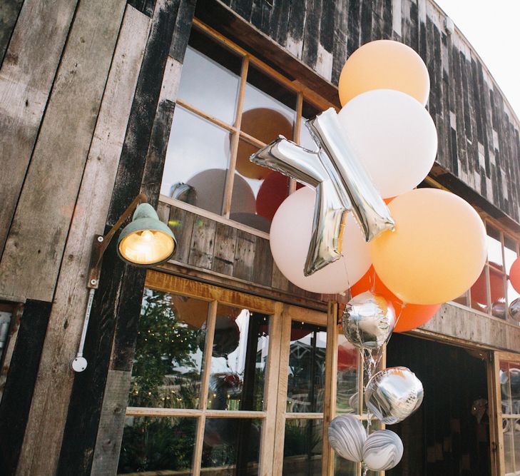 Coloured and Foil Balloons Decorating  the Entrance to the Wedding Venue