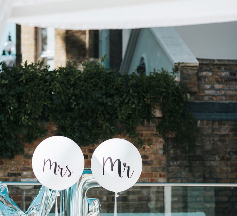 Mr &amp; Mrs Slogan Balloons Tied To the Bride and Grooms Reception Chairs