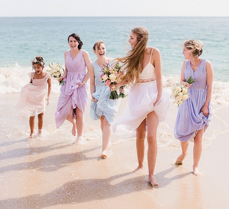 Bridal party portrait on the beach in pastel dresses