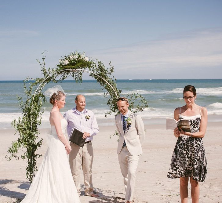 Bride and groom exchanging vows on the beach