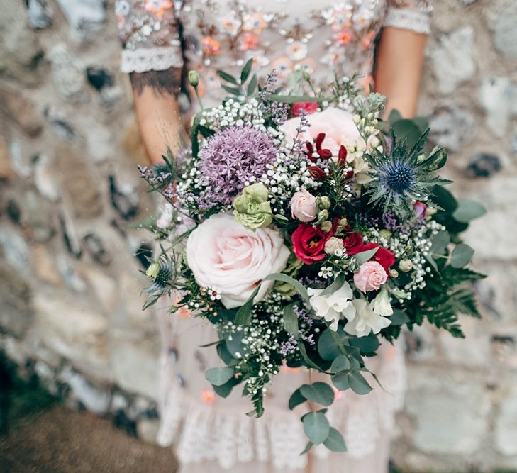 Wedding Bouquet With Thistles And Roses // Beautiful DIY Village Hall Wedding For Under £5k // Guests Made Food // Bride Wears Needle &amp; Thread // Images By Dale Weeks Photography