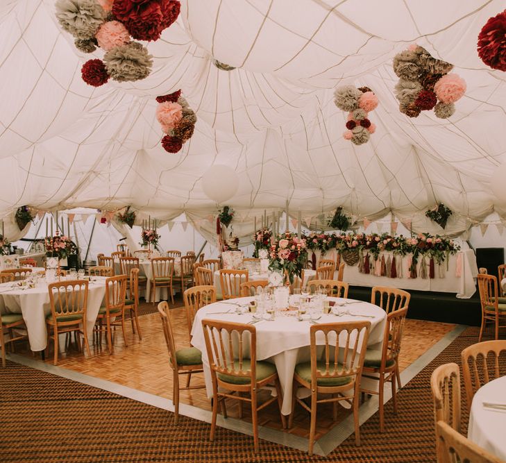 Marquee with Draped Ceiling at The Druidstone | Grey, Blush and Burgundy Pom Poms | Top Table Runner of Blush and Burgundy Flowers with Foliage | Pastel Bunting | Grey Tapered Candles | Rose Gold Candelabras | Giant White Balloons with Grey, Blush and Burgundy Tassels | Table Centrepieces of Blush and Burgundy Flowers with Foliage | Mykonos Rewritten Bridesmaid Dresses for an Epic Clifftop Coastal Wedding | Nic Ford Photography