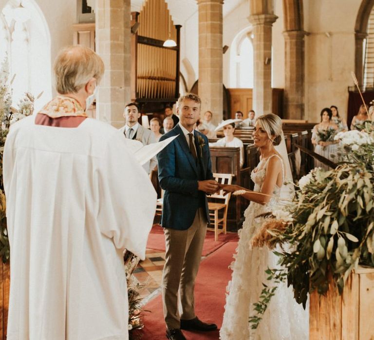 Bride and groom exchanging vows at their August 2020 wedding