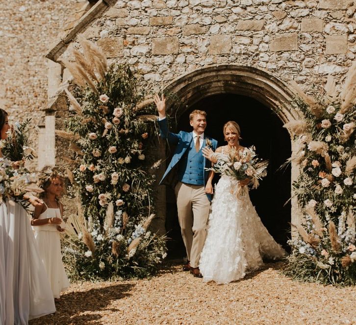 Bride and Groom exiting the church after their August 2020 wedding