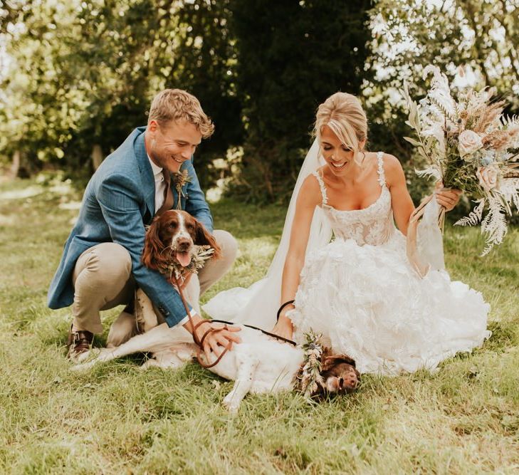 Bride and groom portrait with their pet spaniels in floral collars