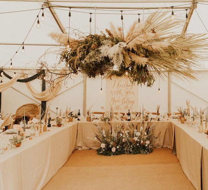 Festoon lights and hanging flower installations with pampas grass for August 2020 wedding reception