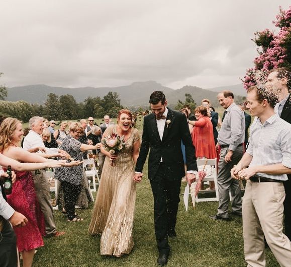 Confetti Exit  with Bride in Sequin Gold Wedding Dress and Groom  in Dark Suit and Wood Bow Tie