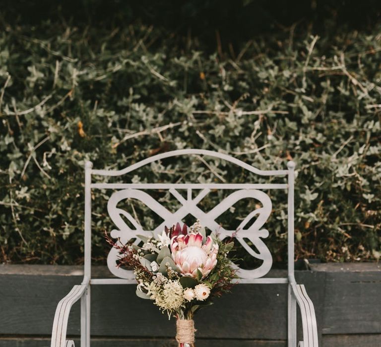 King Protea Bridal Bouquet Sitting on Garden Chair