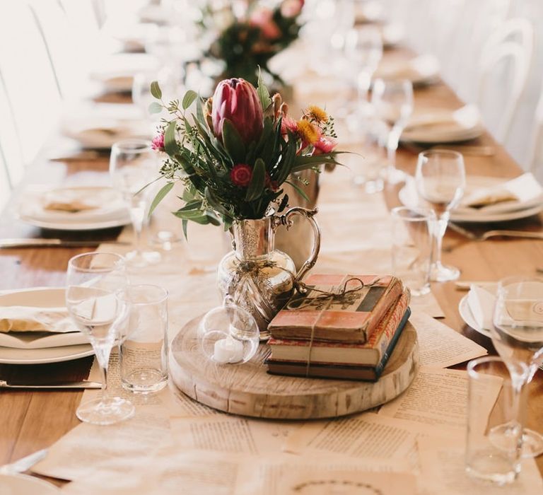 Tree Slice Centrepiece with Vintage Books and Wedding Flowers in Silver Vessel