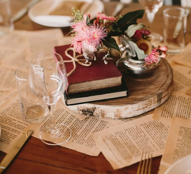 Tree Slice Centrepiece with Antique Books and Pink Flowers in Vase