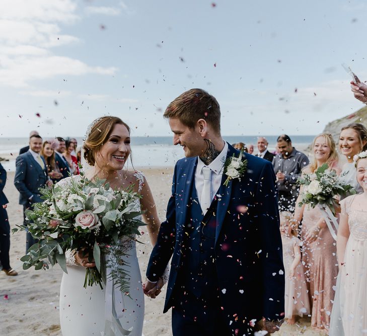 Beach Confetti Moment  | Bride in Lace Long Sleeve Martina Liana Wedding Dress | Groom in Navy Three-piece Suit | Lusty Glaze Beach Wedding Newquay Cornwall | Alexa Poppe PhotographyLusty Glaze Beach Wedding Newquay Cornwall | Alexa Poppe Photography