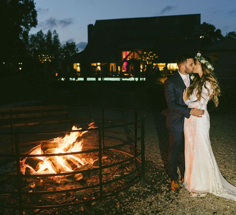 Bride and Groom During Evening By Fire