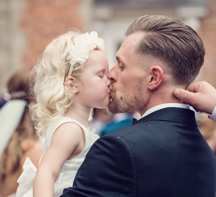 Groom in Gieves &amp; Hawkes Tuxedo Kissing his Flower Girl Daughter