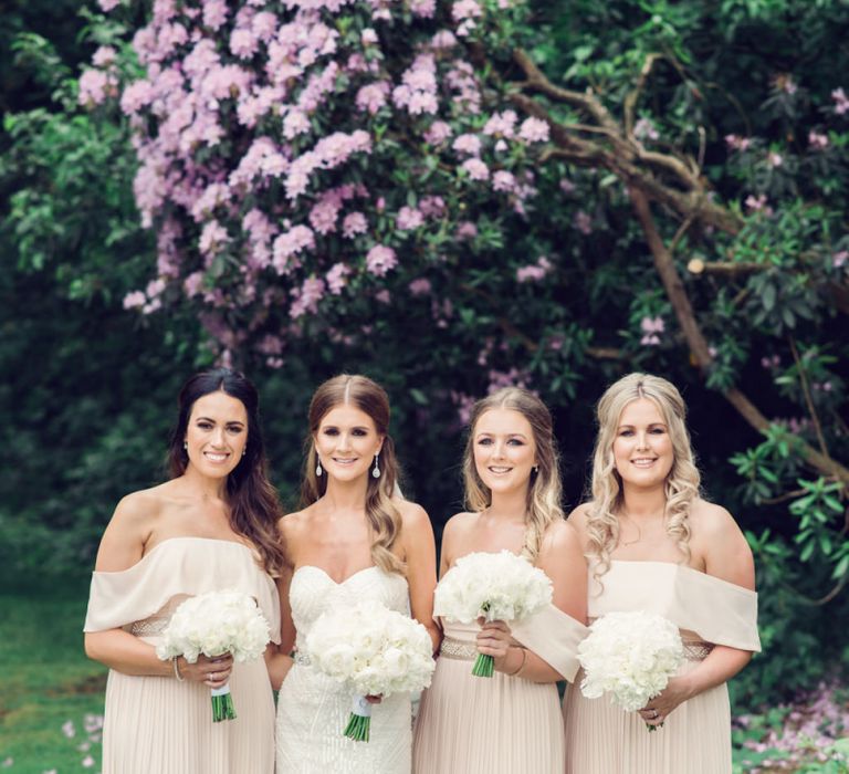 Bridal Party with Bridesmaids in Pale Pink Off the Shoulder Dresses and Bride in Beaded Fishtail Wedding Dress