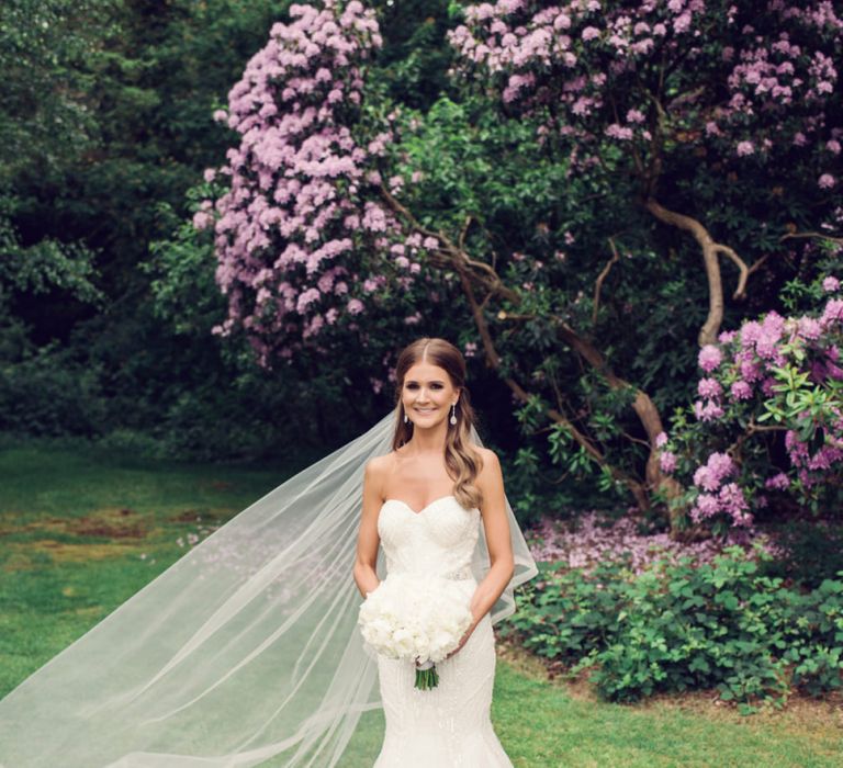 Beautiful Bride in Beaded Fishtail Wedding Dress with Corset Top and Wedding Veil