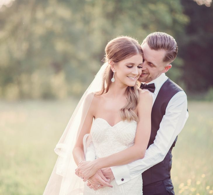 Golden Hour Portrait of Bride in Beaded Fishtail Wedding Dress and Groom in Gieves &amp; Hawkes Tuxedo