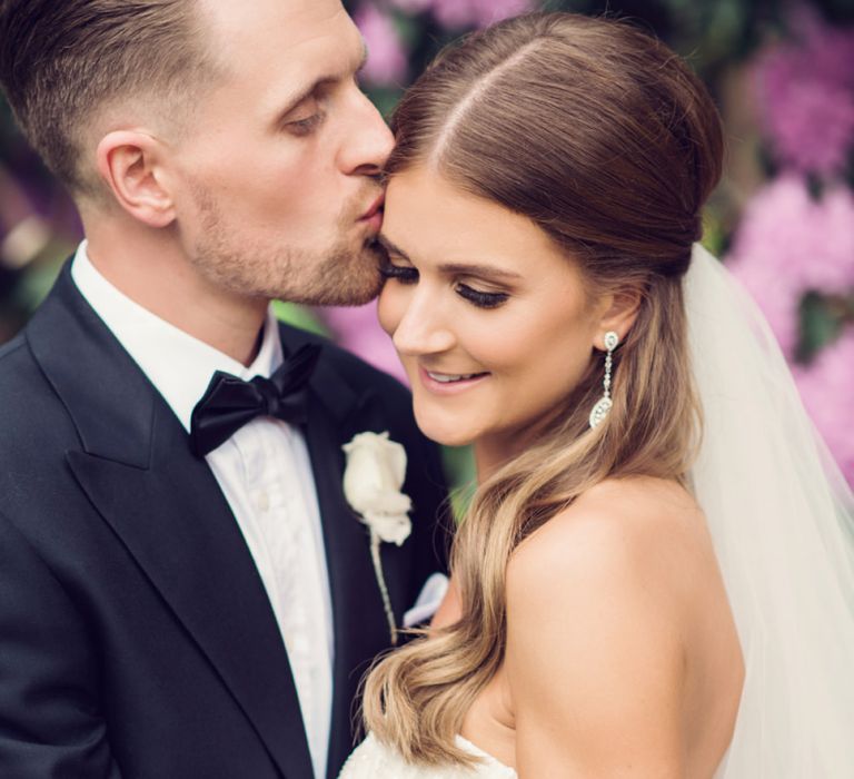 Groom in Gieves &amp; Hawkes Tuxedo Kissing His Beautiful Bride