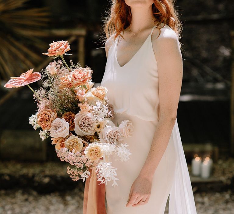 Bride in Thin Star Wedding Dress with Orange Flower Wedding Bouquet