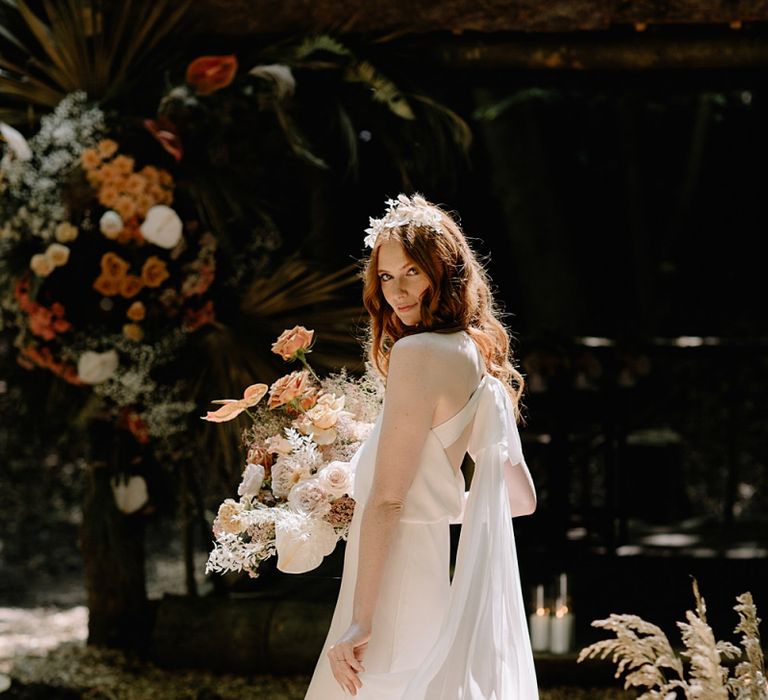 Bride in Fitted Wedding Dress with Tie Back Holding a Dried Flower Bouquet