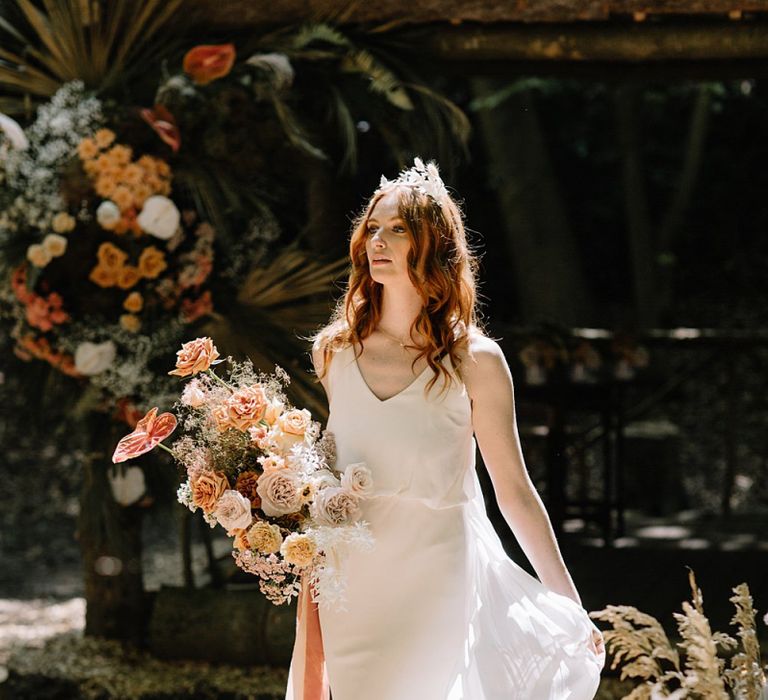 Beautiful Bride in Fitted Wedding Dress with Orange Flower Bouquet