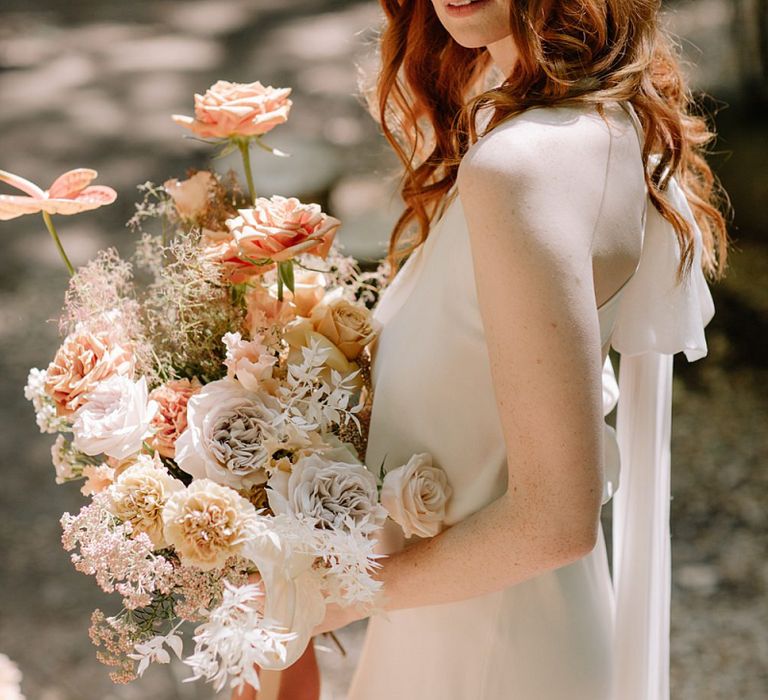 Natural Bridal Beauty Holding a Dried Flower and Orange Wedding Bouquet