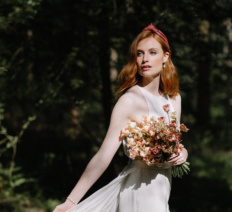 Bride in Halterneck Wedding Dress and Turban Headband with Orange Flower Bouquet