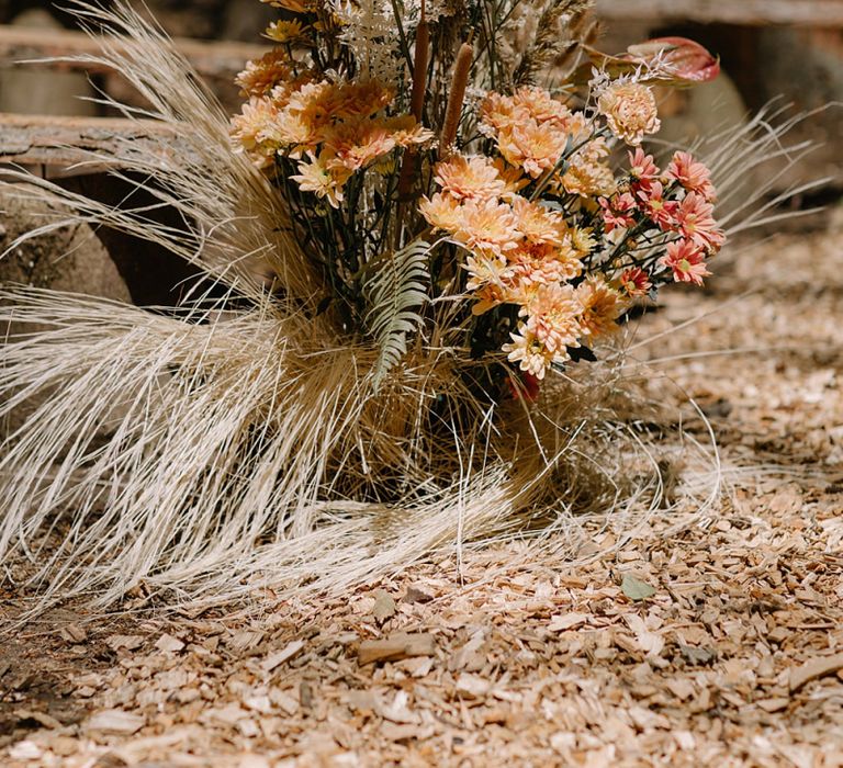 Wooden Benches and Floral Arrangements of Dried Grasses &amp; Orange Flowers