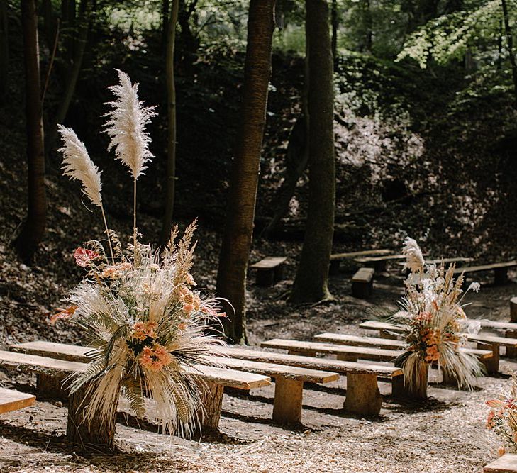 Outdoor Woodland Ceremony with Dried Grass and Orange Flower Arrangements