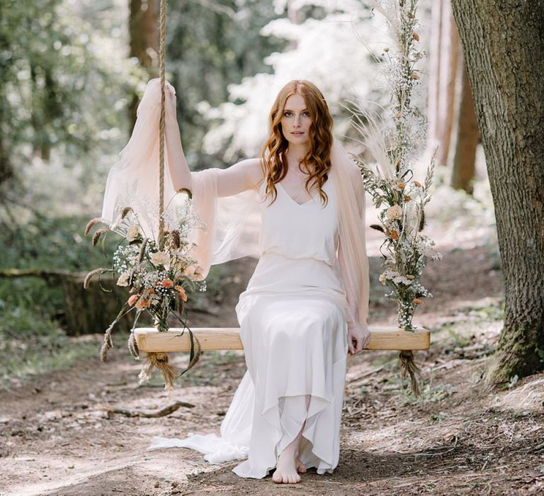 Whimsical Bride on a Swing Decorated with Flowers