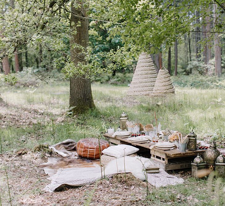 Relaxed Grazing Table in the Woodland with Poufs, blankets and Cushions