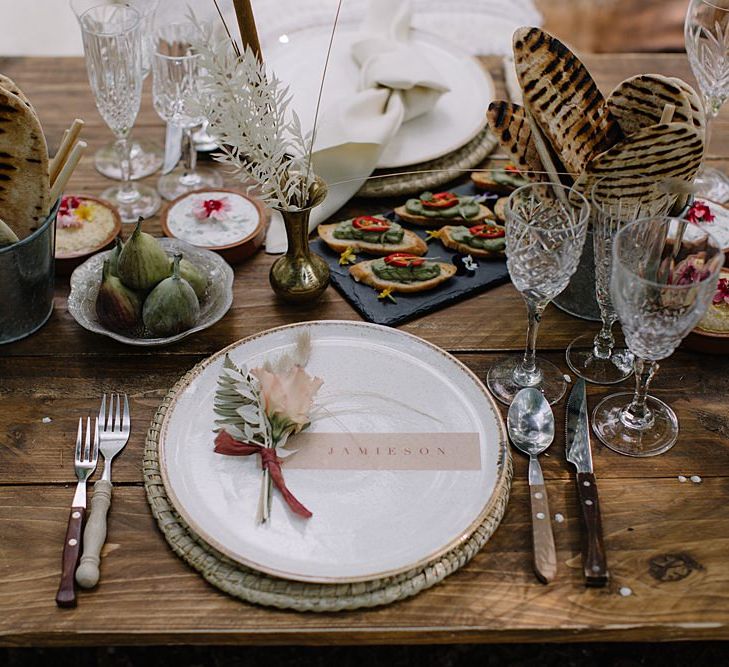 Low Wooden Table with Wicker Place Setting and Elegant Place Setting Card