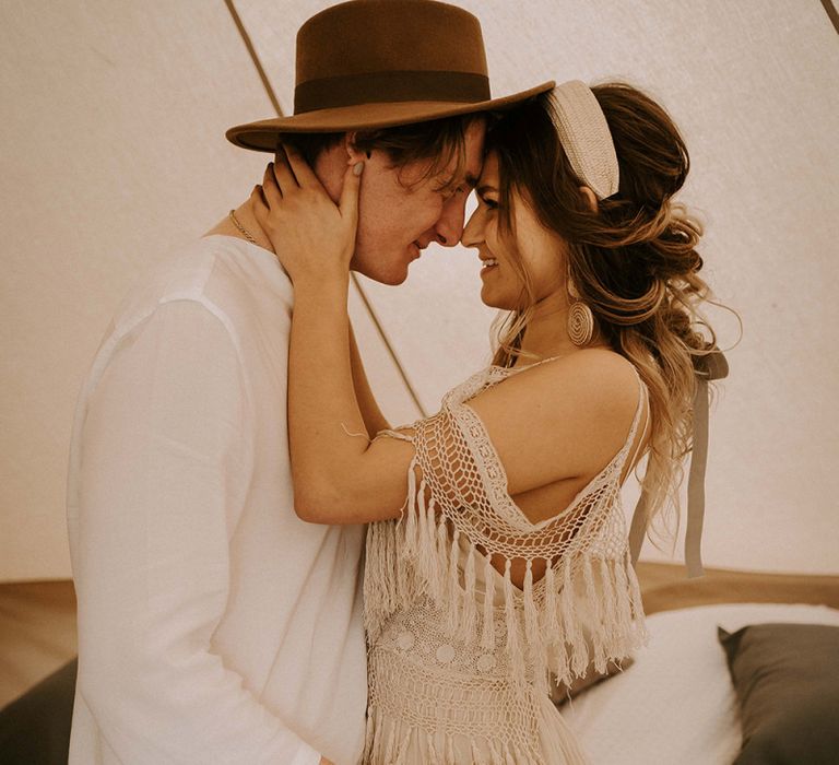 Boho Couple Embracing in a Bell Tent