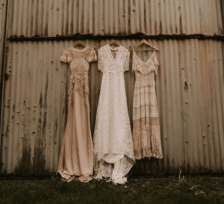 Three Boho Wedding Dresses hanging Up with Lace and Fringe Detail