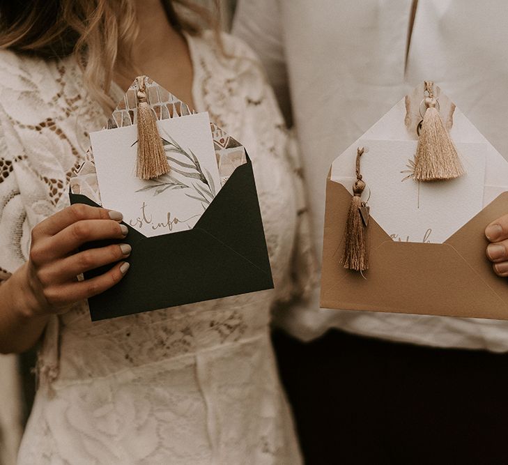 Bride and Groom Holding the Wedding Invitation with Tassel Detail