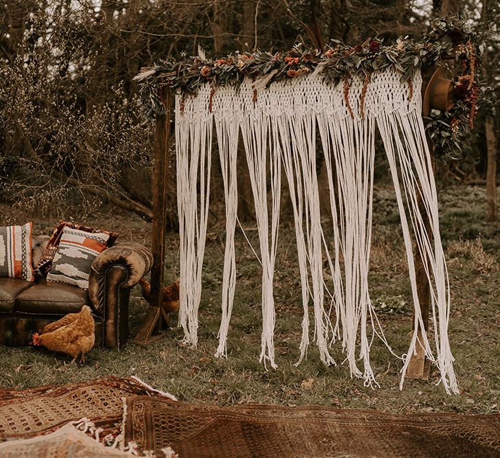 Wooden Frame Altar with Macrame and Flower Decor, plus Vintage Sofa and Moroccan Rugs