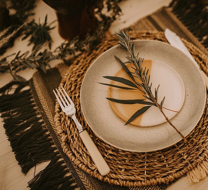 Place Setting with Ceramic Plate, Wicker Place Mat and Ivory Knife and Fork