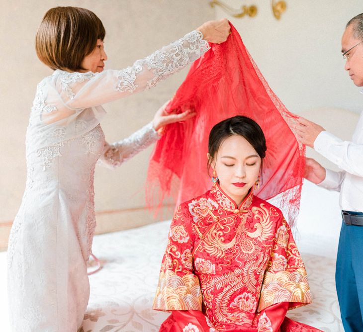 Bride in Traditional Chinese Red Dress with Parents