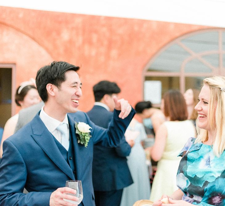 Groom in Three Piece Suit Taking to Wedding Guests