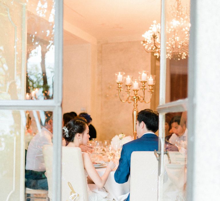 Bride in Anna Kara Wedding Dress and Groom in Three-piece Navy Wedding Suit At Their Wedding Breakfast