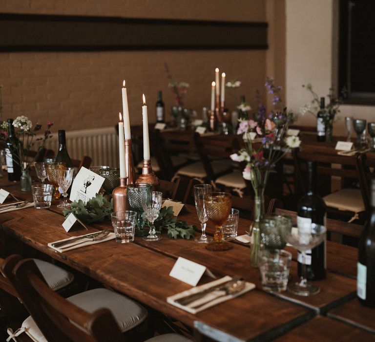 Wooden Trestle Tables With Copper Painted Bottles &amp; Ivory Tapered Candles // James Frost Photography