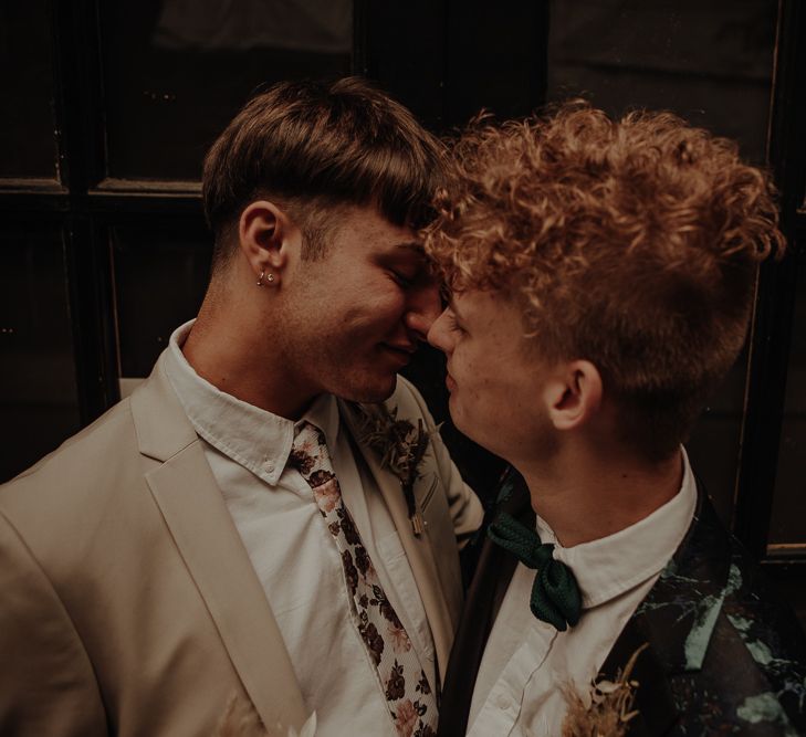 Same sex couple kissing at elopement