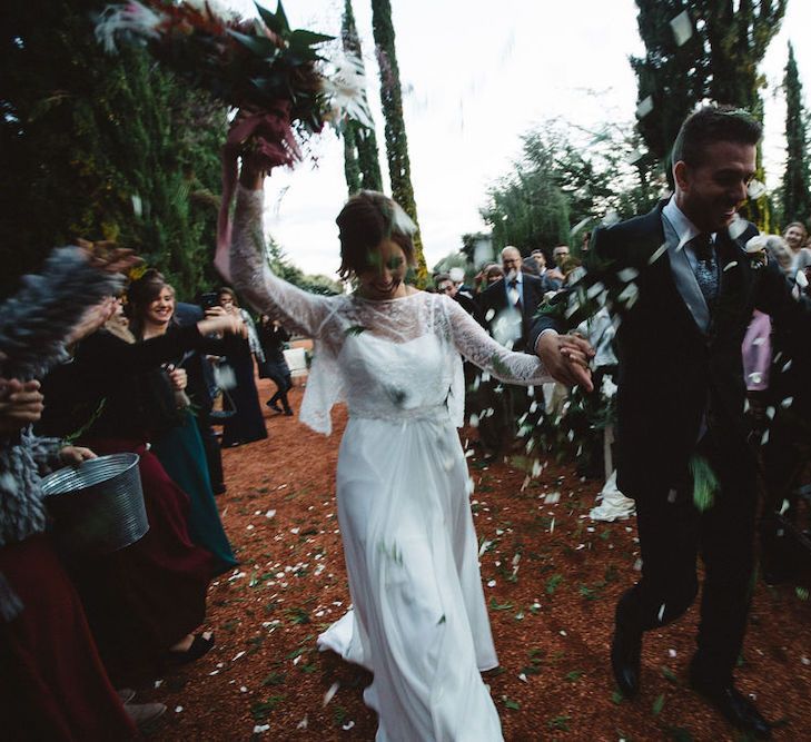 Bride in  Jordi Anguera Wedding Dress and Groom in Señor Suit Walking Up The Aisle as Husband &amp; Wife