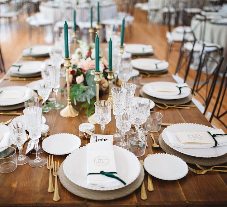 Elegant Table Setting with Gold Candlesticks and Green Taper Candles