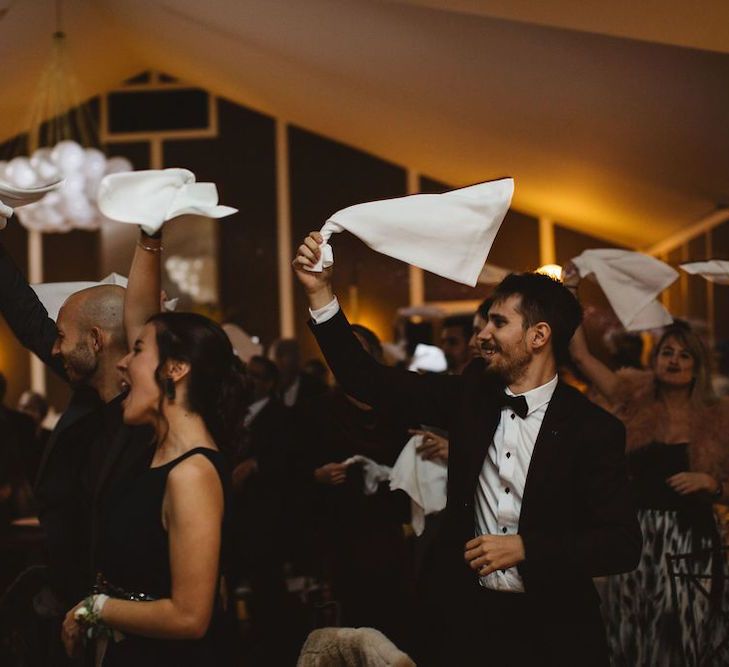 Wedding Guests Waving Their Napkins as the Bride and Groom Enter the Wedding Breakfast