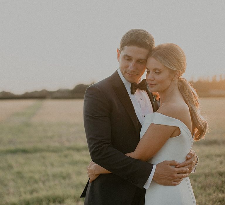 Bride in Suzanne Neville Bardot Nouveau Wedding Dress | Groom in Black Tie | Pastel Pink &amp; Mint Green Wedding at Granary Estates Suffolk | Julia &amp; You Photography