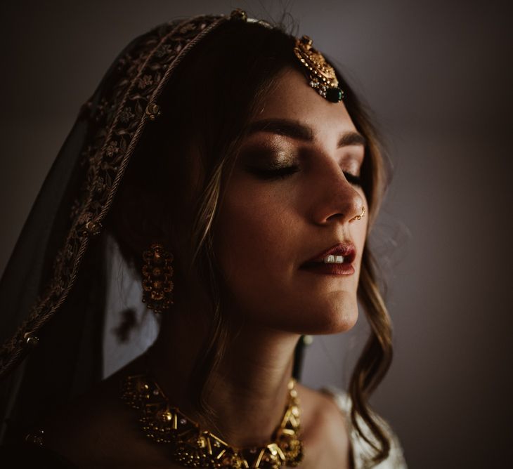 Bride in traditional Indian wedding dress and and bridal accessories