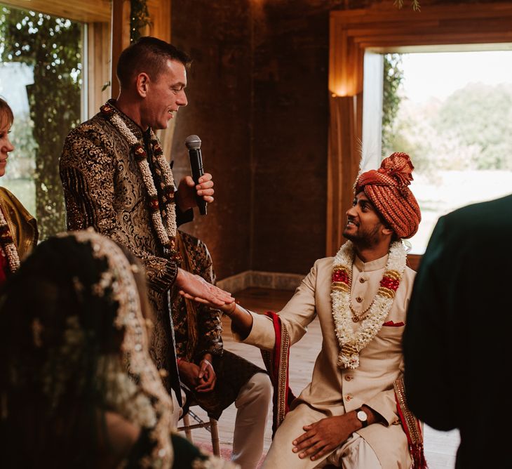 Bride's father shaking the grooms hand at Hindu wedding ceremony